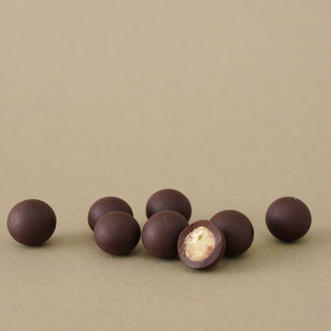 Crystallized ginger spheres covered with 100% dark chocolate